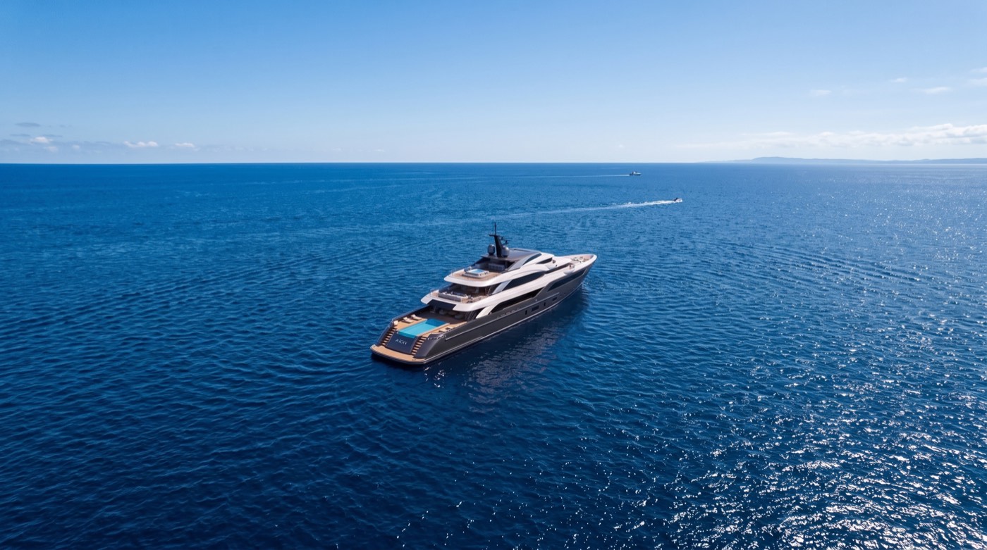 Superyacht cruising open ocean, three-quarter exterior view