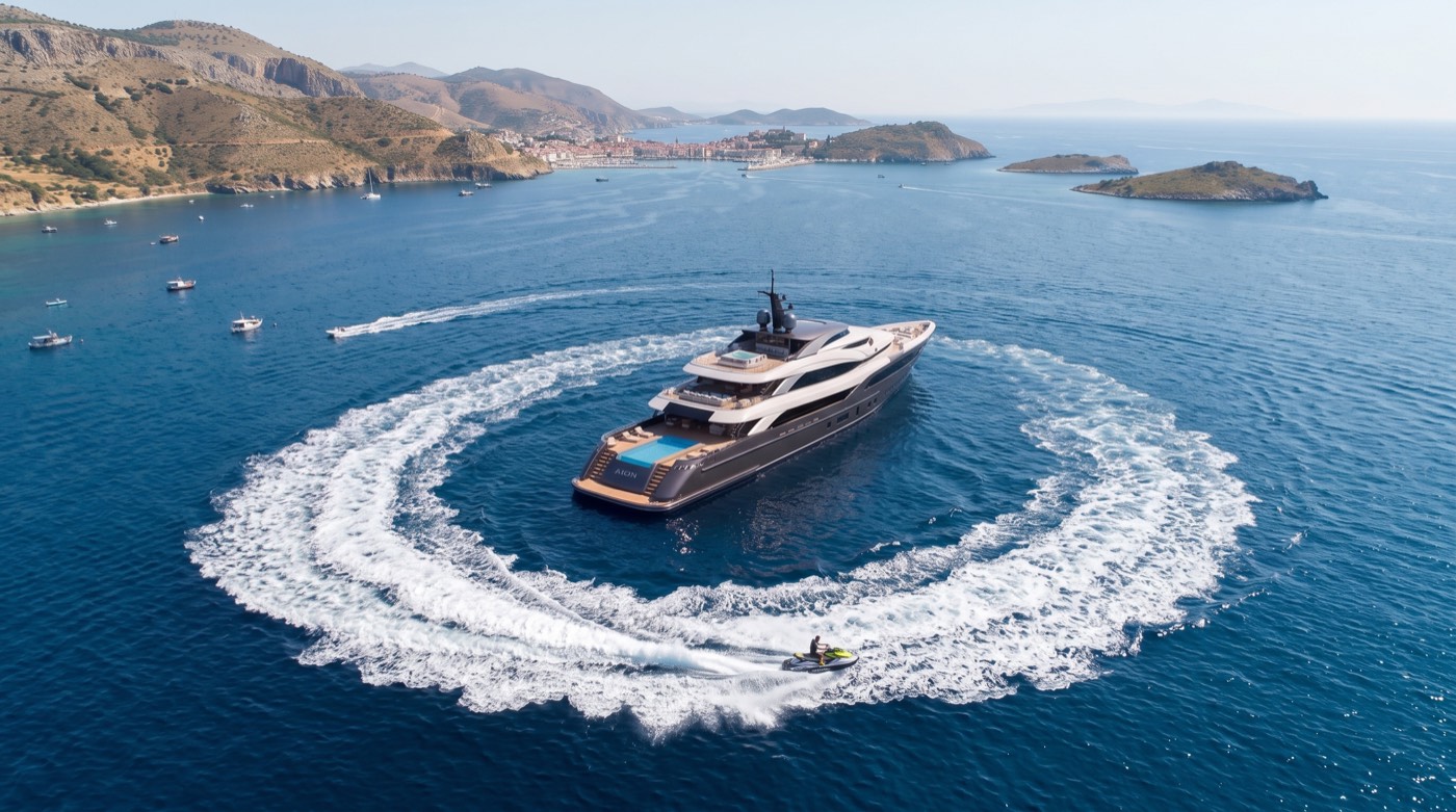 Aerial render of a yacht carving a circular wake near islands